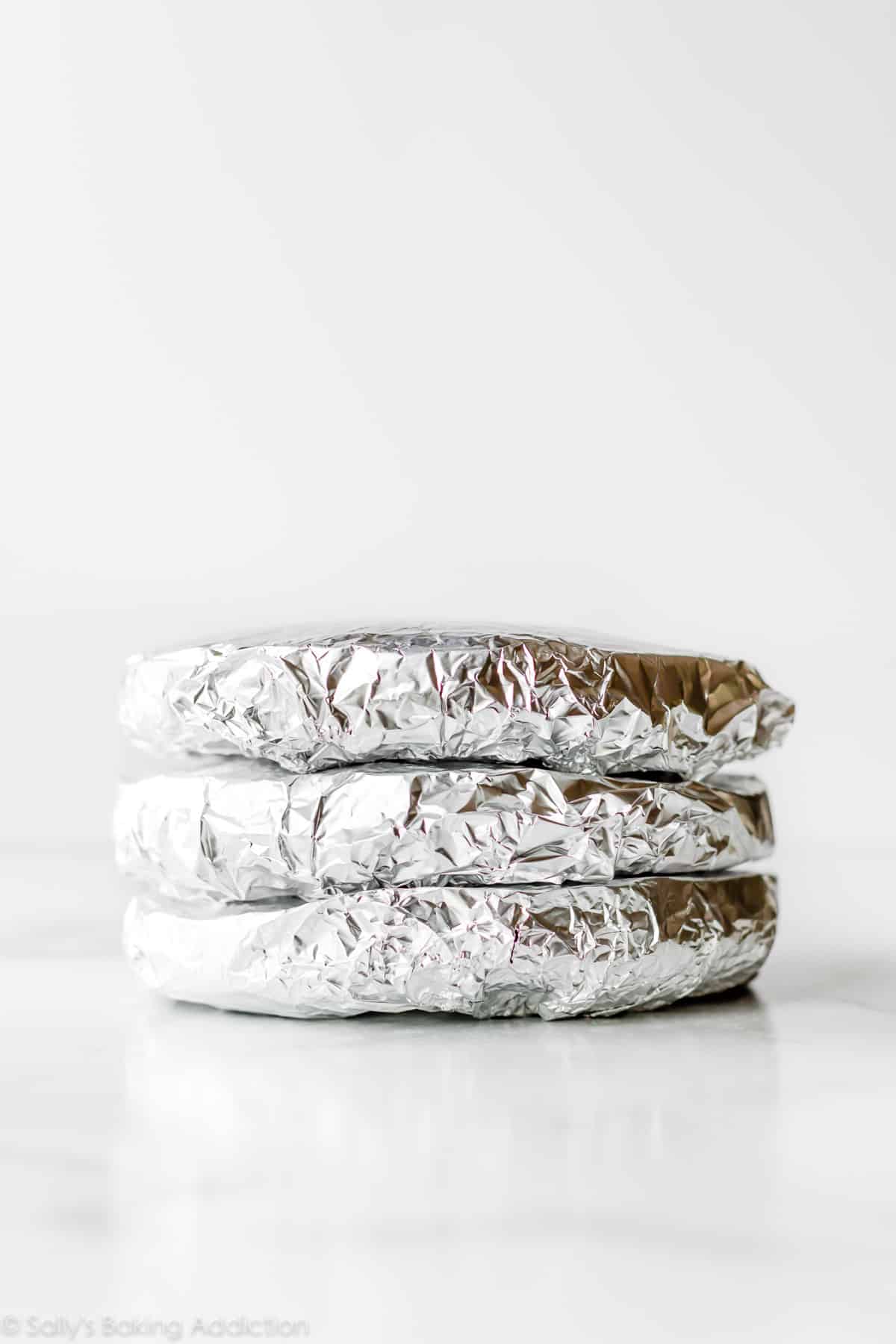 stack of cakes wrapped in aluminum foil