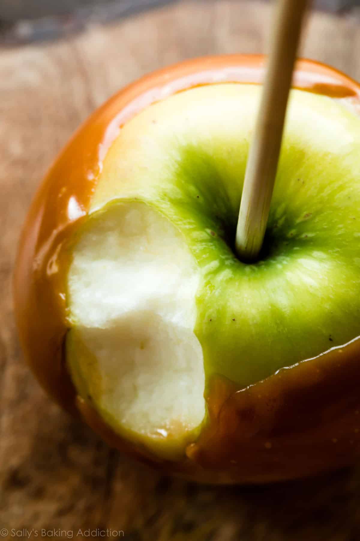 homemade caramel apple with a bite taken out