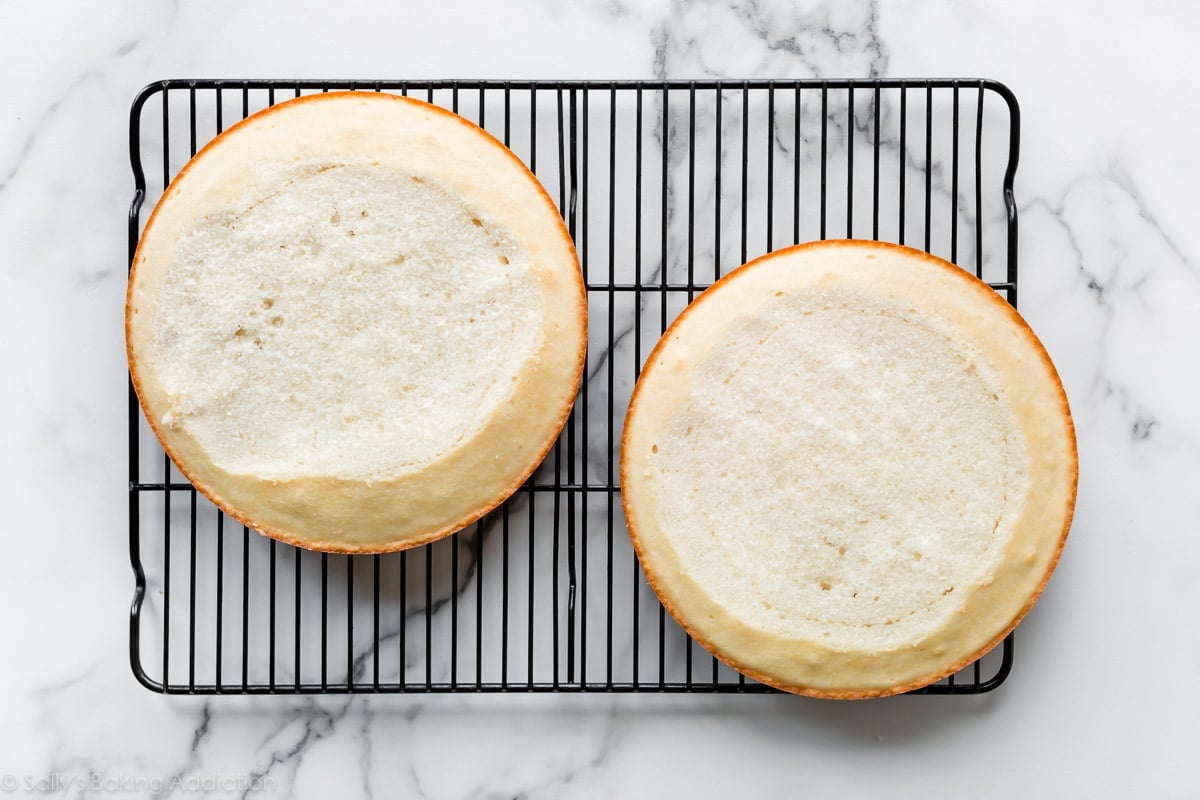 2 leveled white cakes on a cooling rack