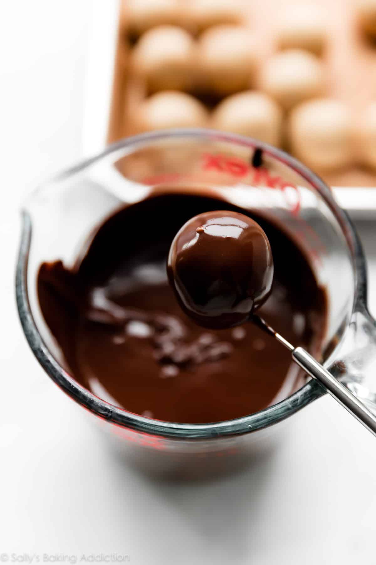 dipping peanut butter balls in chocolate