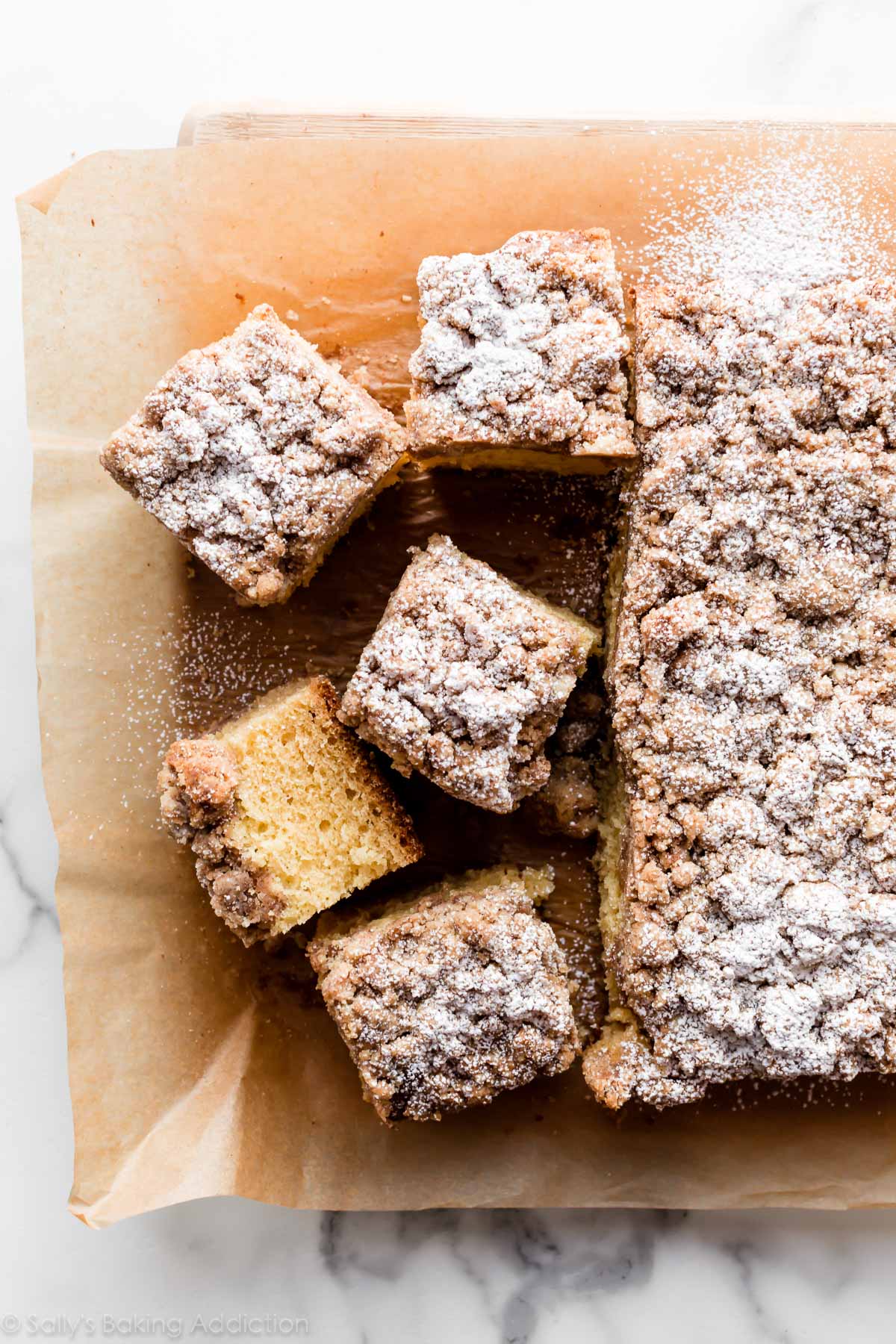 sliced New York crumb cake on parchment paper