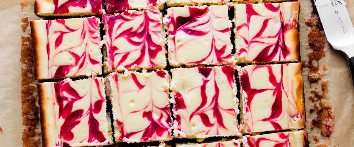 white chocolate raspberry cheesecake bars cut into squares