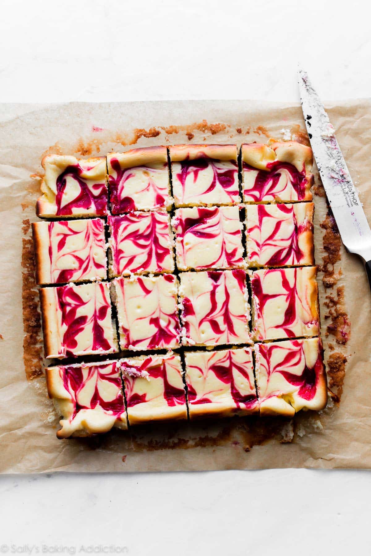 white chocolate raspberry cheesecake bars cut into squares