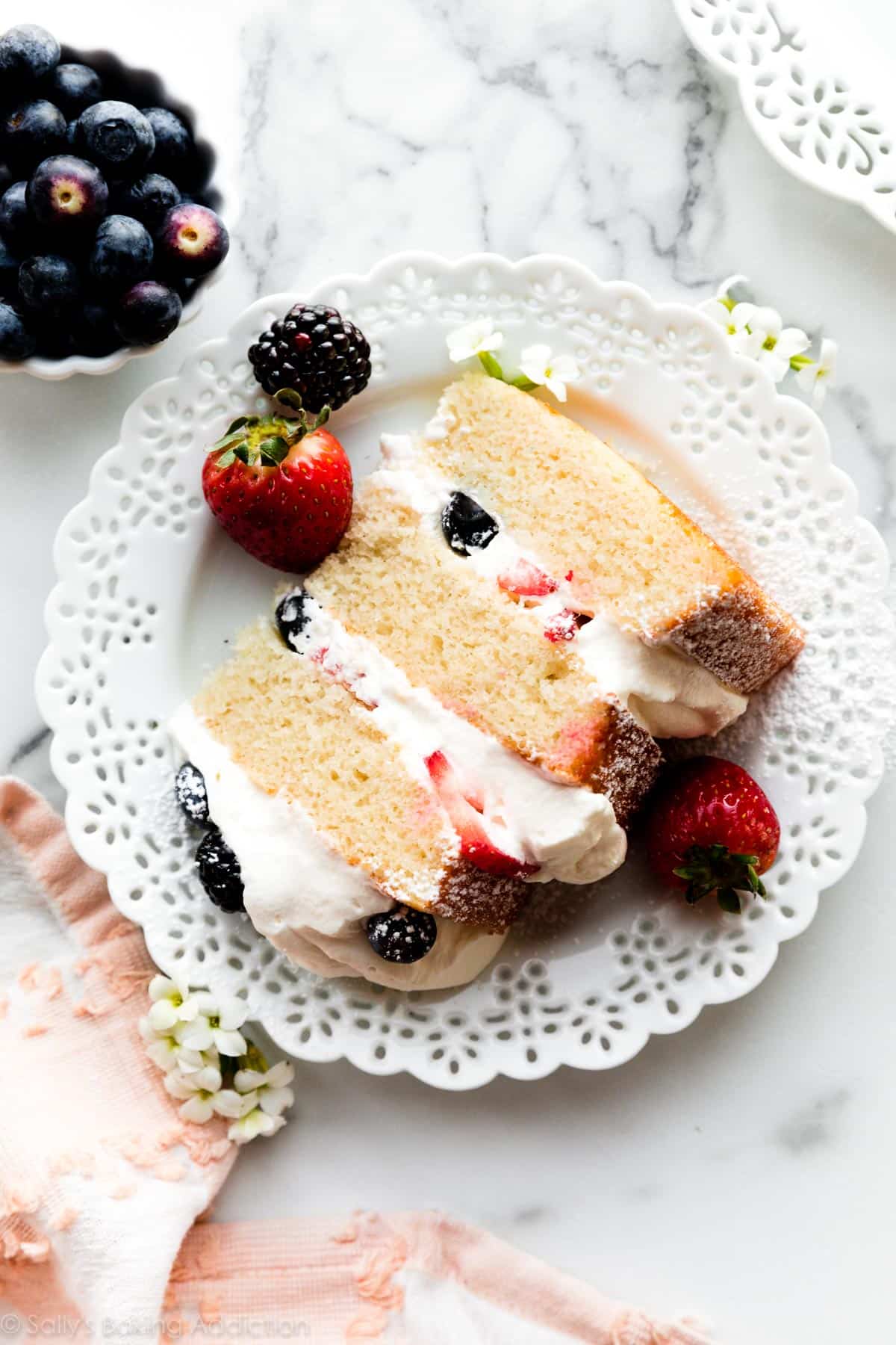 slice of white cake with whipped cream and berries