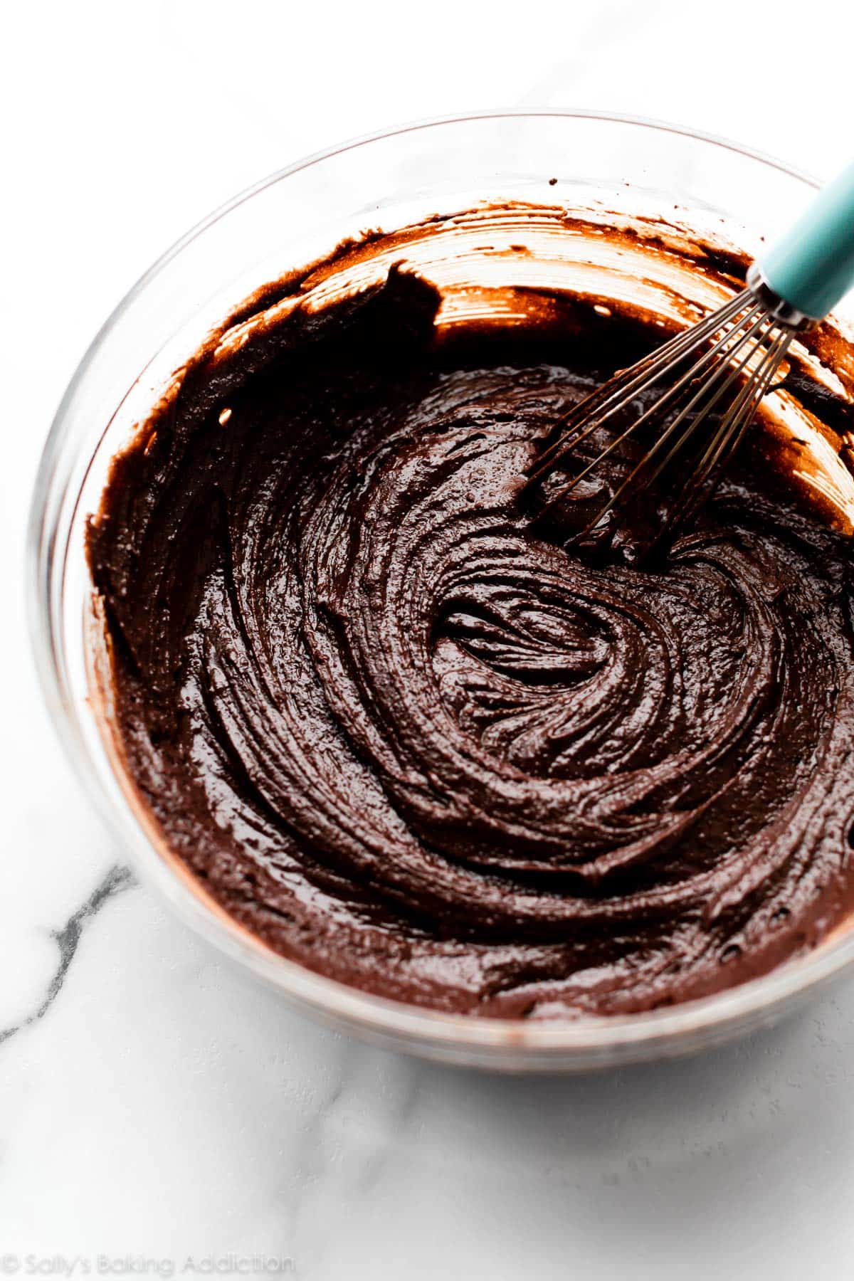 homemade brownie batter in glass bowl