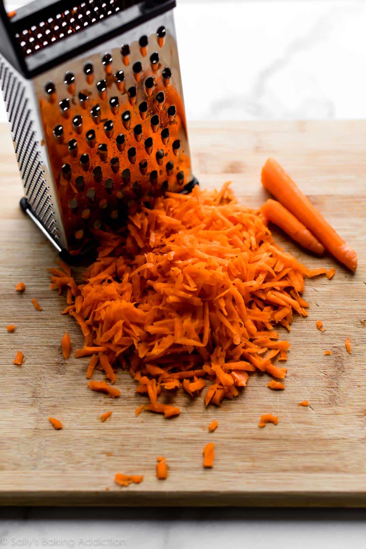 shredded carrots on wood cutting board