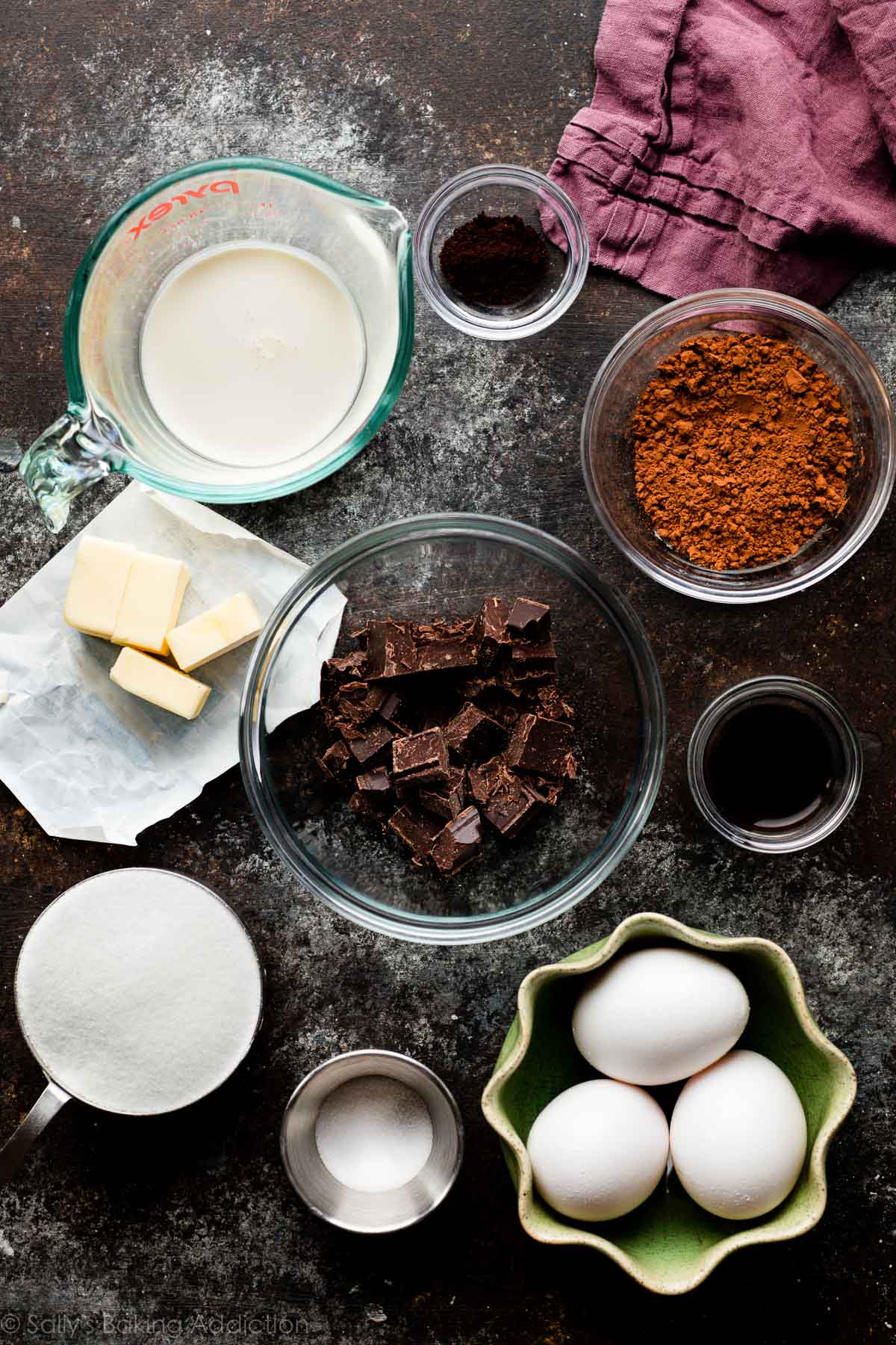 bowls of ingredients including cocoa powder, eggs, sugar, and chocolate