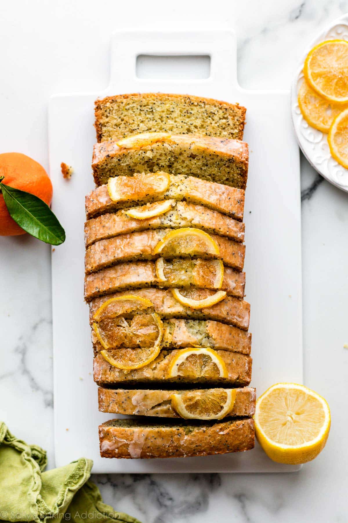 sliced lemon poppy seed quick bread with candied lemons on top