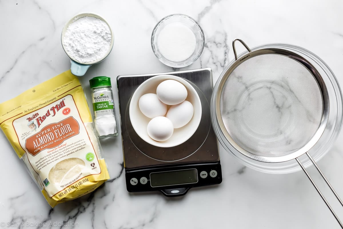 ingredients and tools including almond flour, eggs, food scale, and sugar