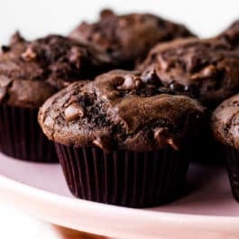 double chocolate chip muffins on pink cake stand