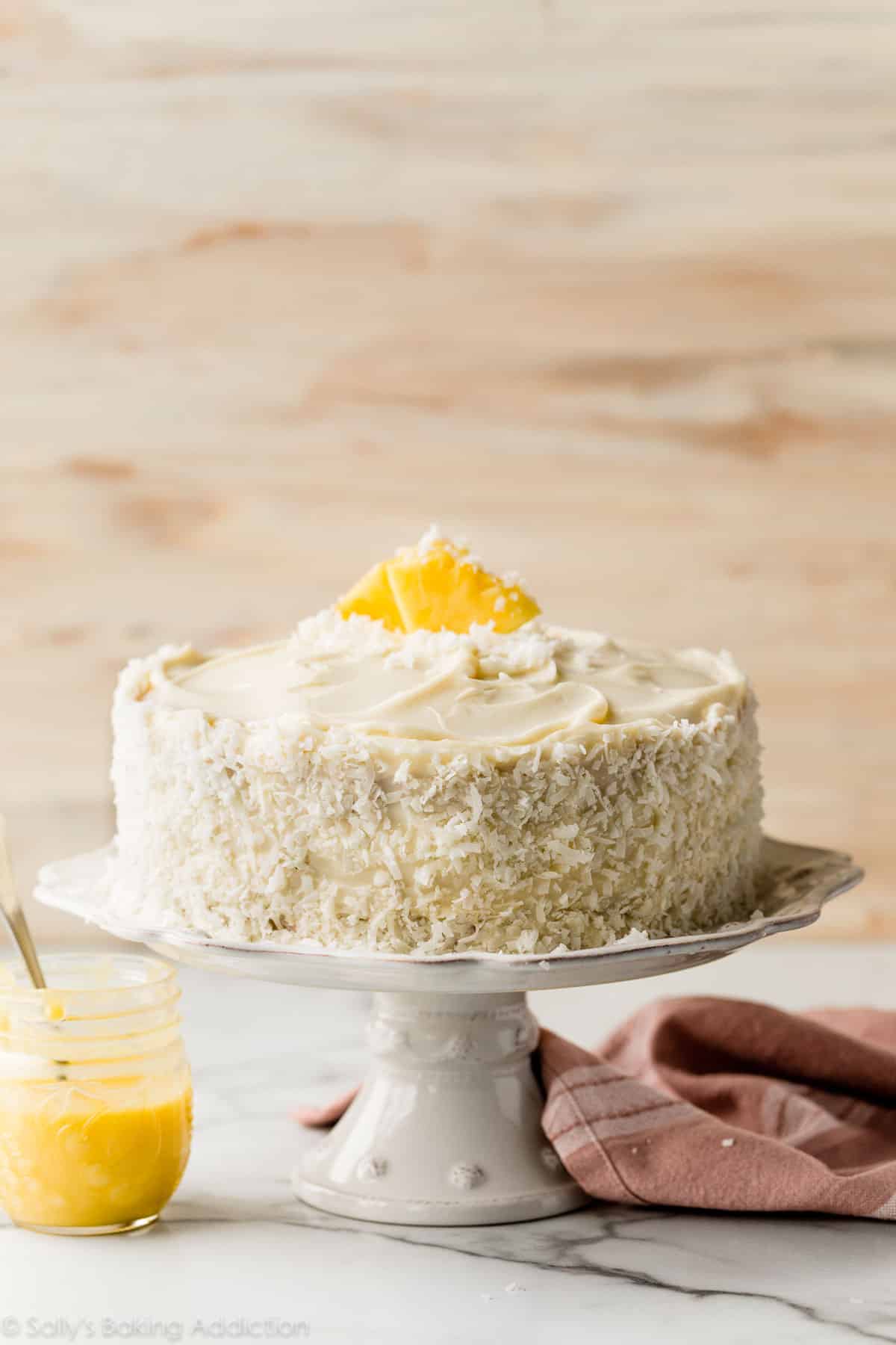 pineapple coconut cake on white cake stand
