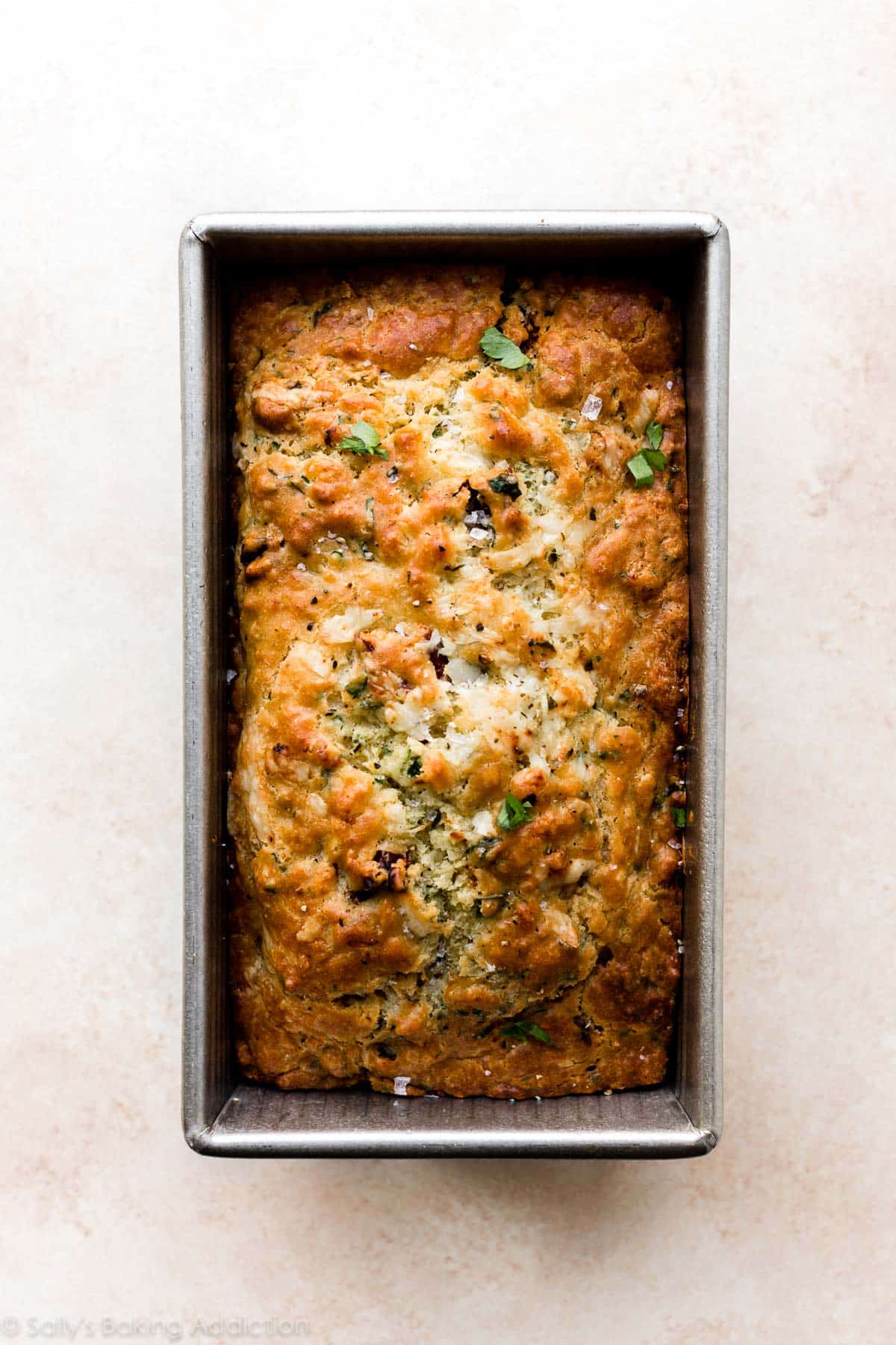 asiago cheese and sun-dried tomato quick bread in loaf pan