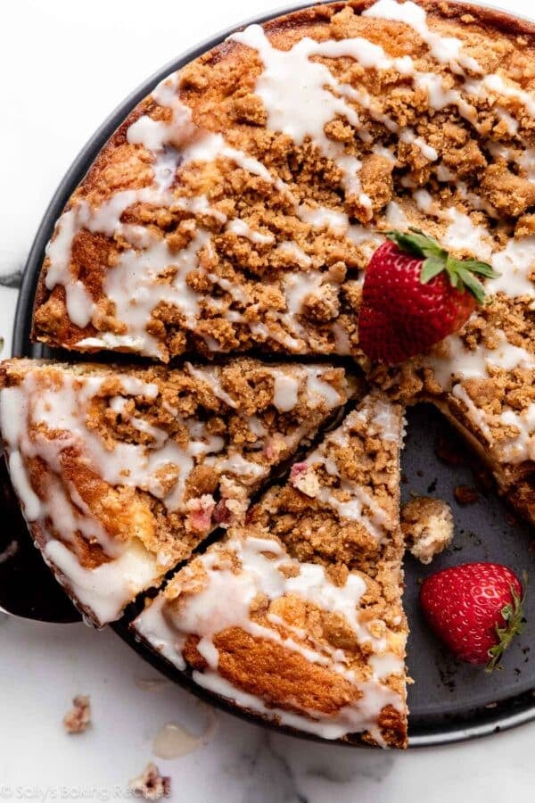 strawberry cream cheese crumb cake with crumb topping and icing.