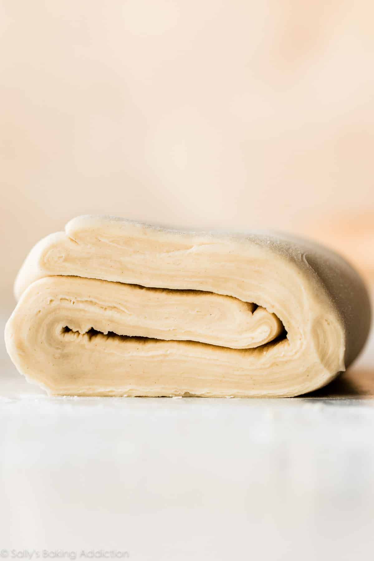 homemade puff pastry dough displaying all the layers of folded dough and butter inside