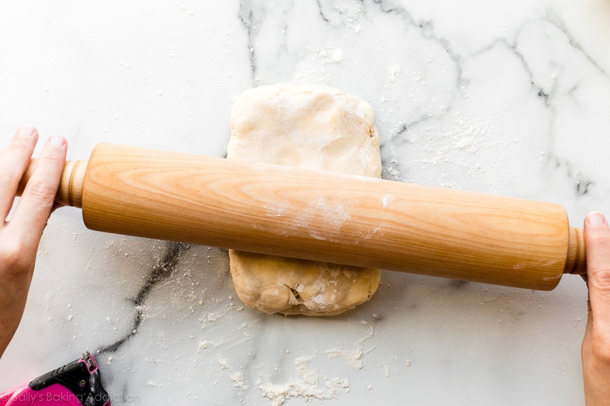 rolling out puff pastry dough with rolling pin