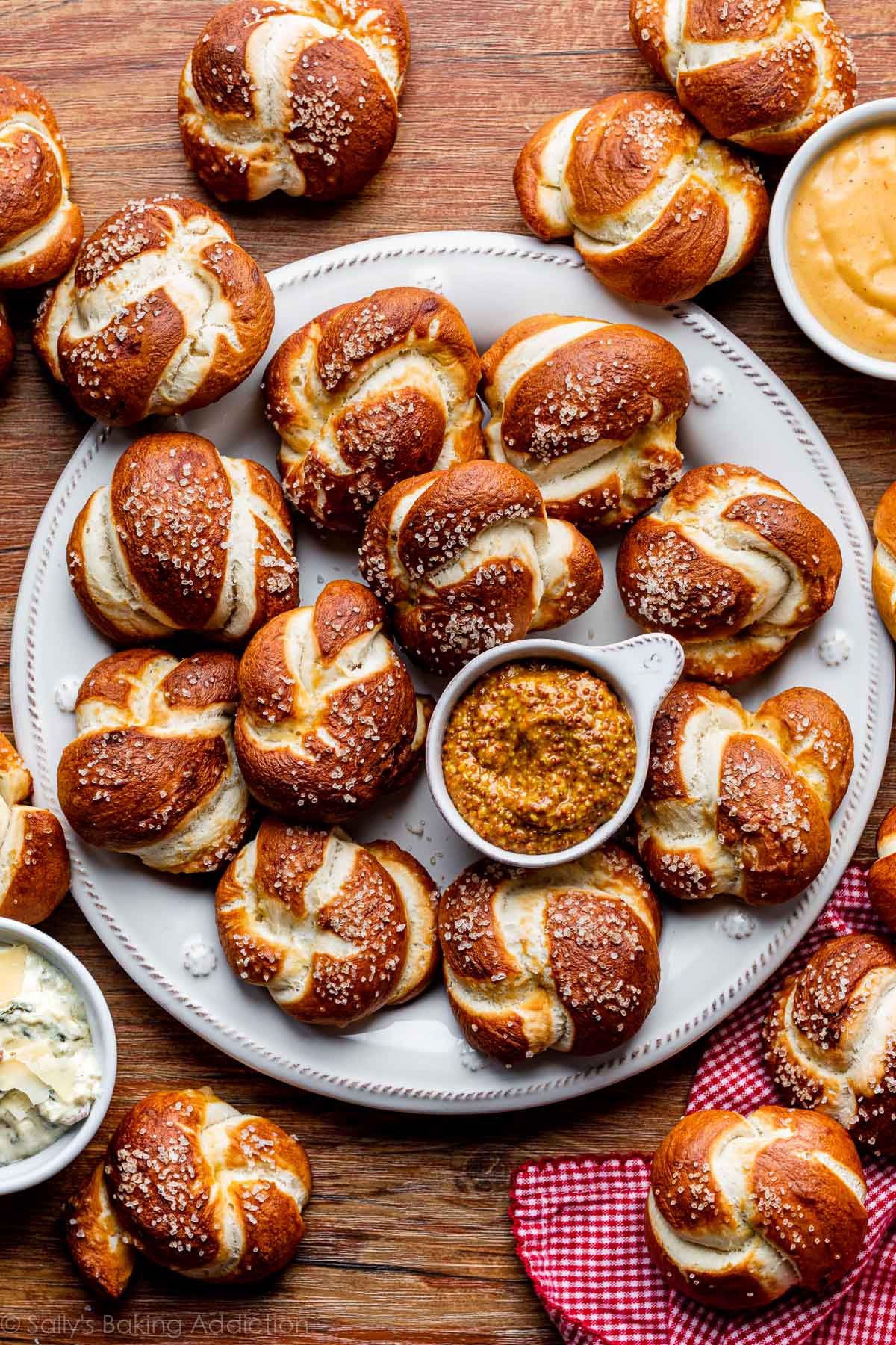 soft pretzel knots on white plate served with mustard