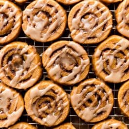 pumpkin cinnamon roll cookies with maple icing on top