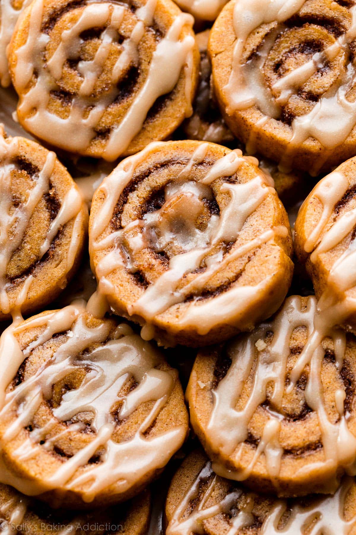 close up photo of pumpkin swirl cookies with maple icing on top