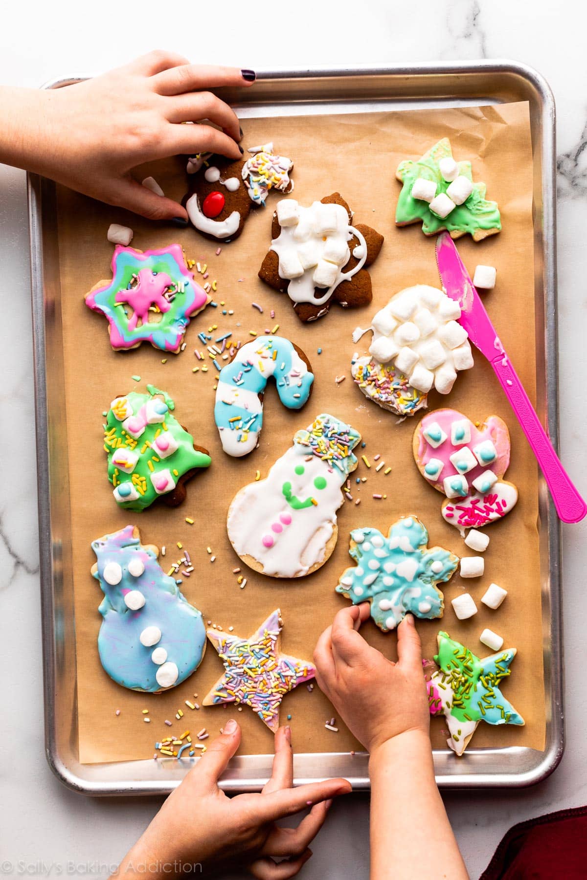 decorated cookies on a lined baking sheet