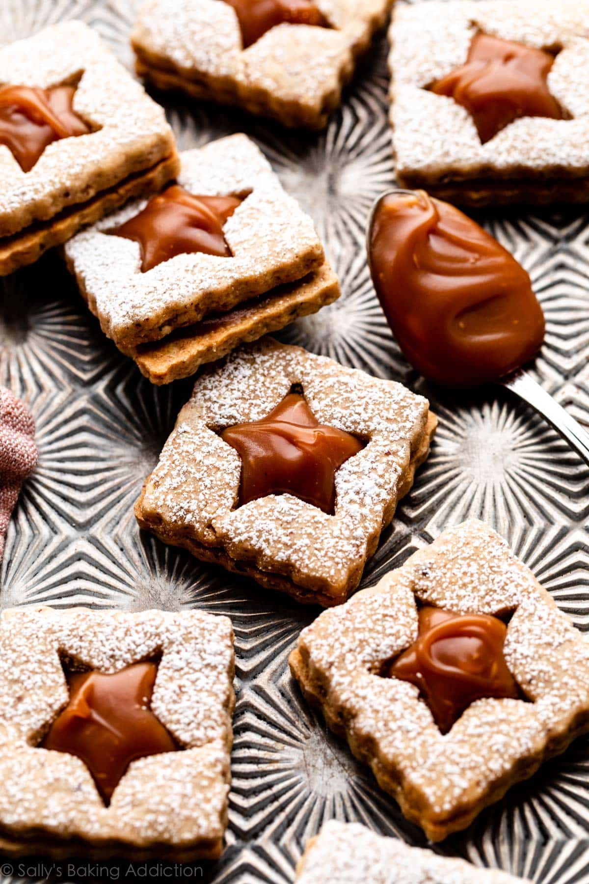 square-shaped hazelnut linzer cookie sandwiches with homemade caramel
