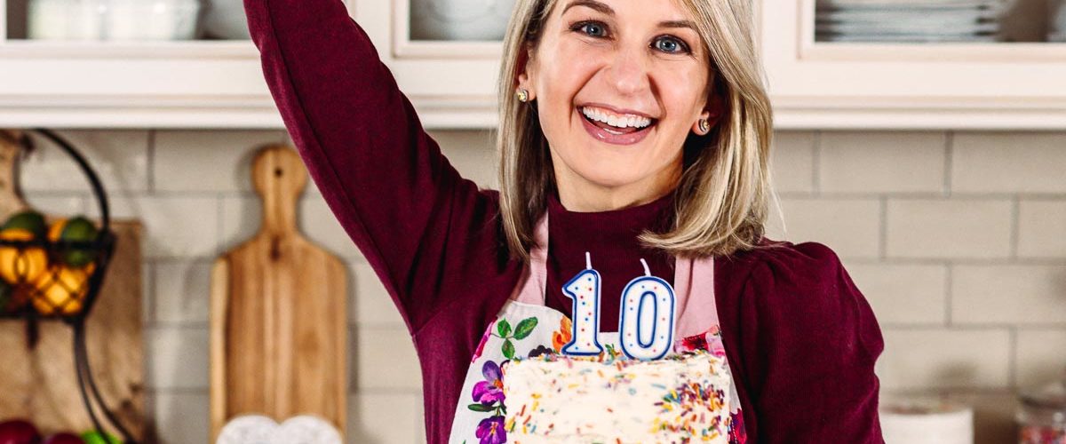 sally holding sprinkle cake with number 10 candles