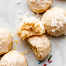 glazed lemon coconut drop shortbread-style cookies with coconut on top