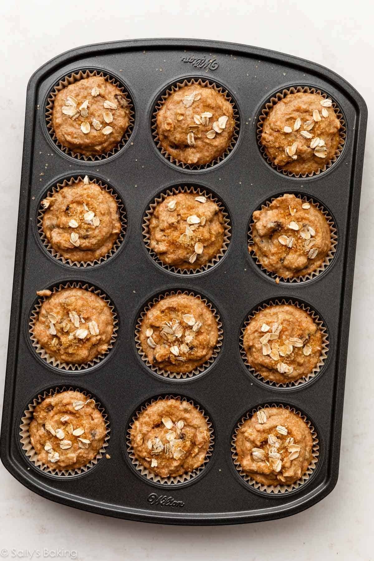 muffin batter with oats on top in muffin pan.