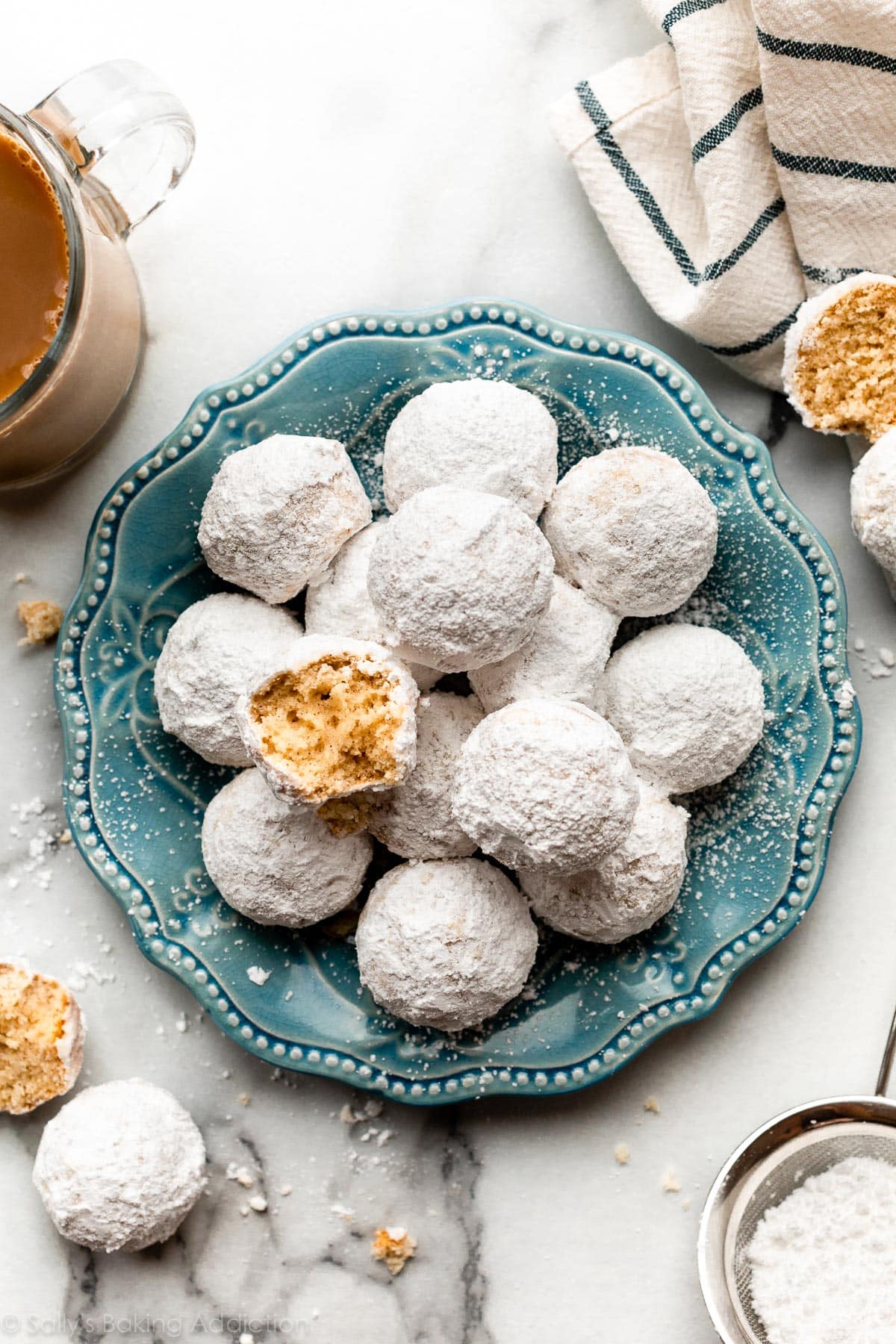 mini powdered sugar donut muffins on blue plate