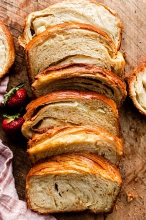 sliced croissant bread on wooden cutting board