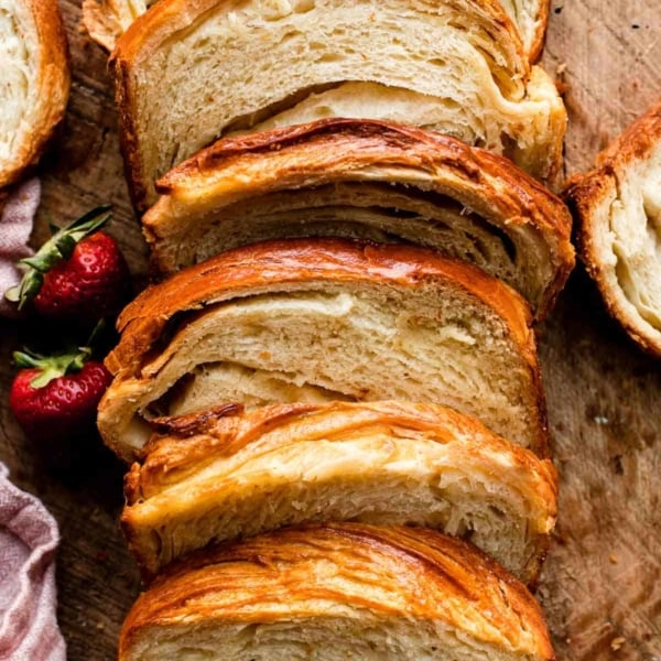 sliced croissant bread on wooden cutting board