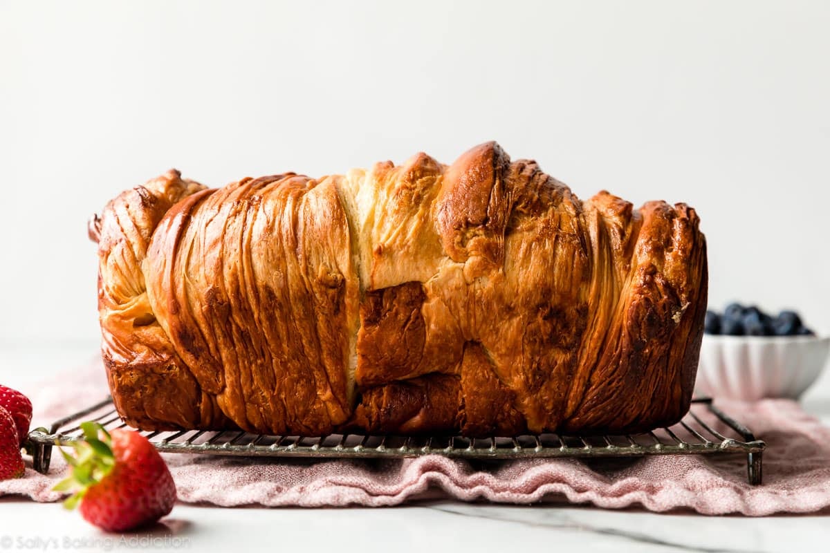 layered golden brown croissant bread on wire rack