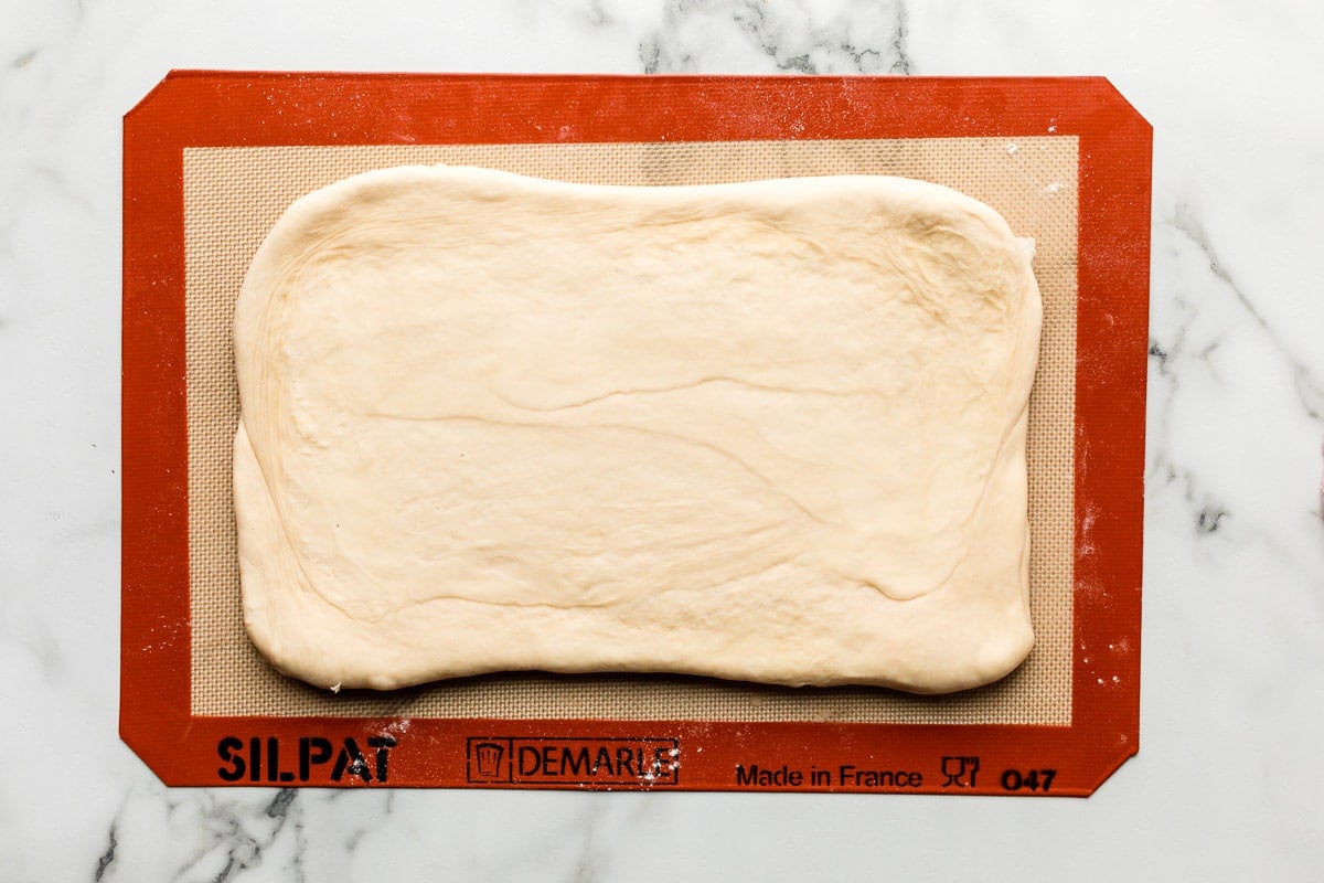 rolled out laminated dough on lined baking sheet