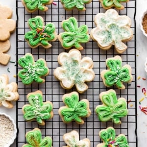 shamrock shaped sugar cookies with green and white buttercream frosting