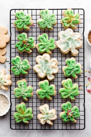 shamrock shaped sugar cookies with green and white buttercream frosting