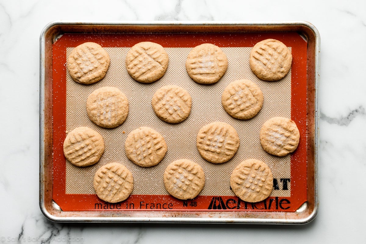 Peanut butter cookies on a lined baking sheet