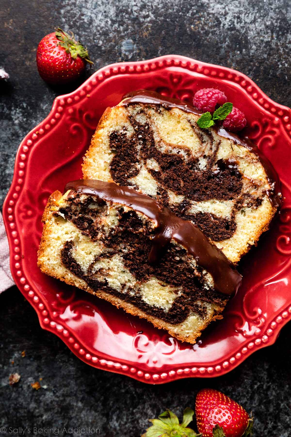 two slices of marble loaf cake on red plate
