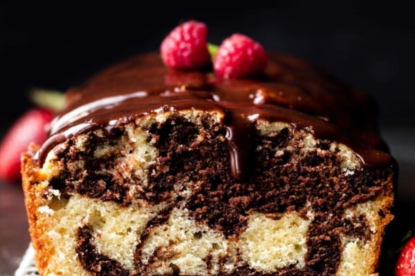 marble loaf cake with ganache and raspberries on top