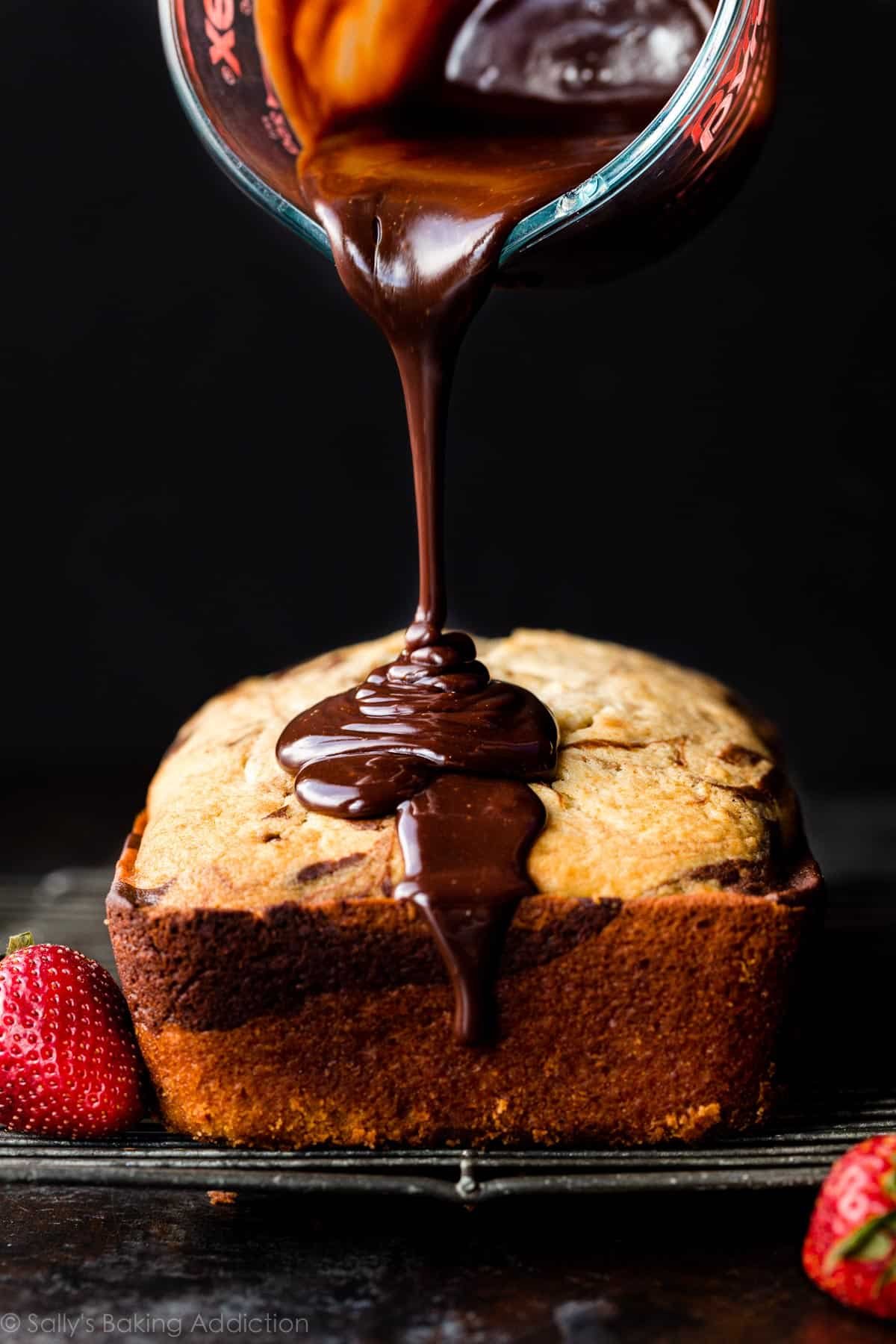 pouring chocolate ganache on loaf cake
