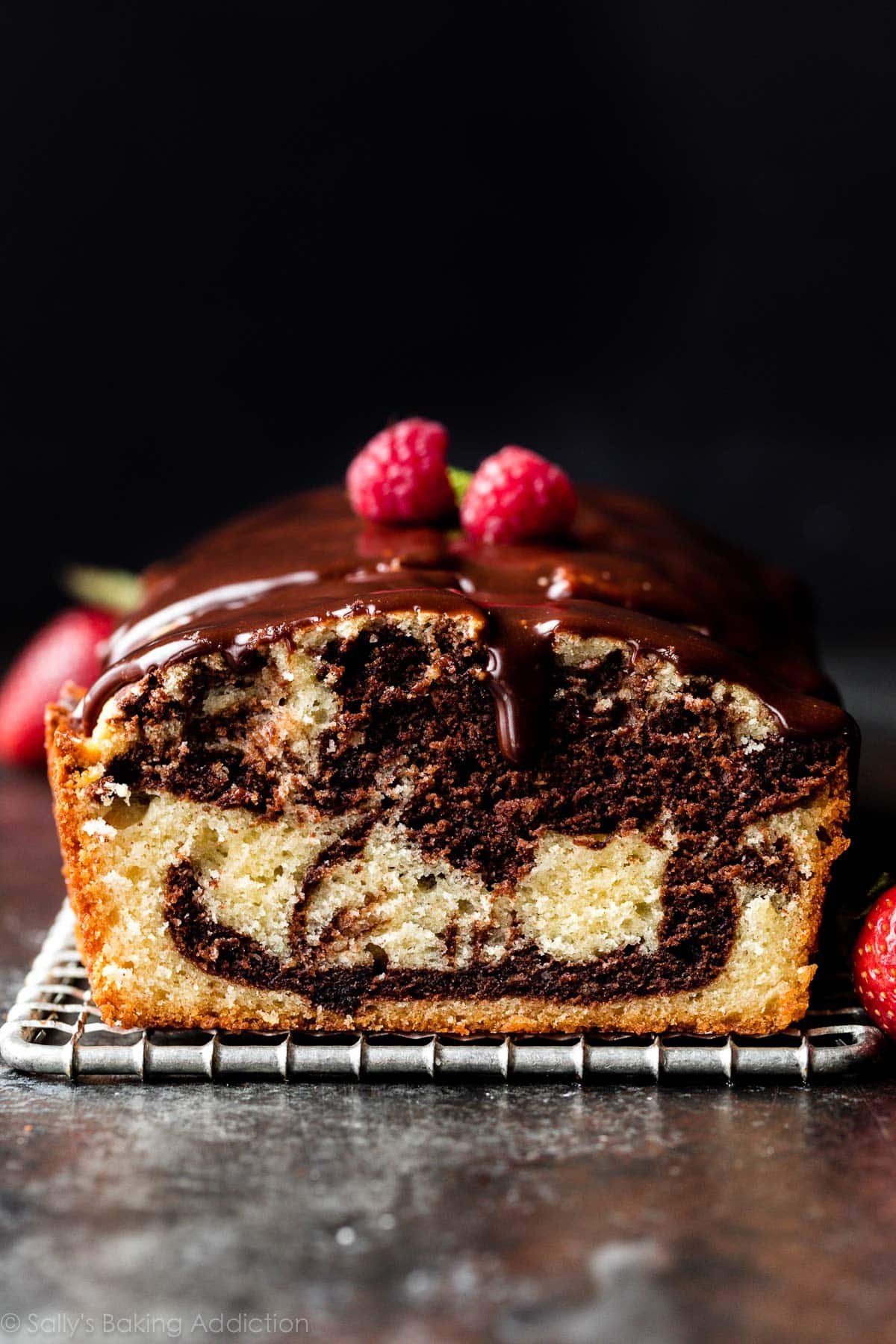 Marble cake covered with ganache and berries