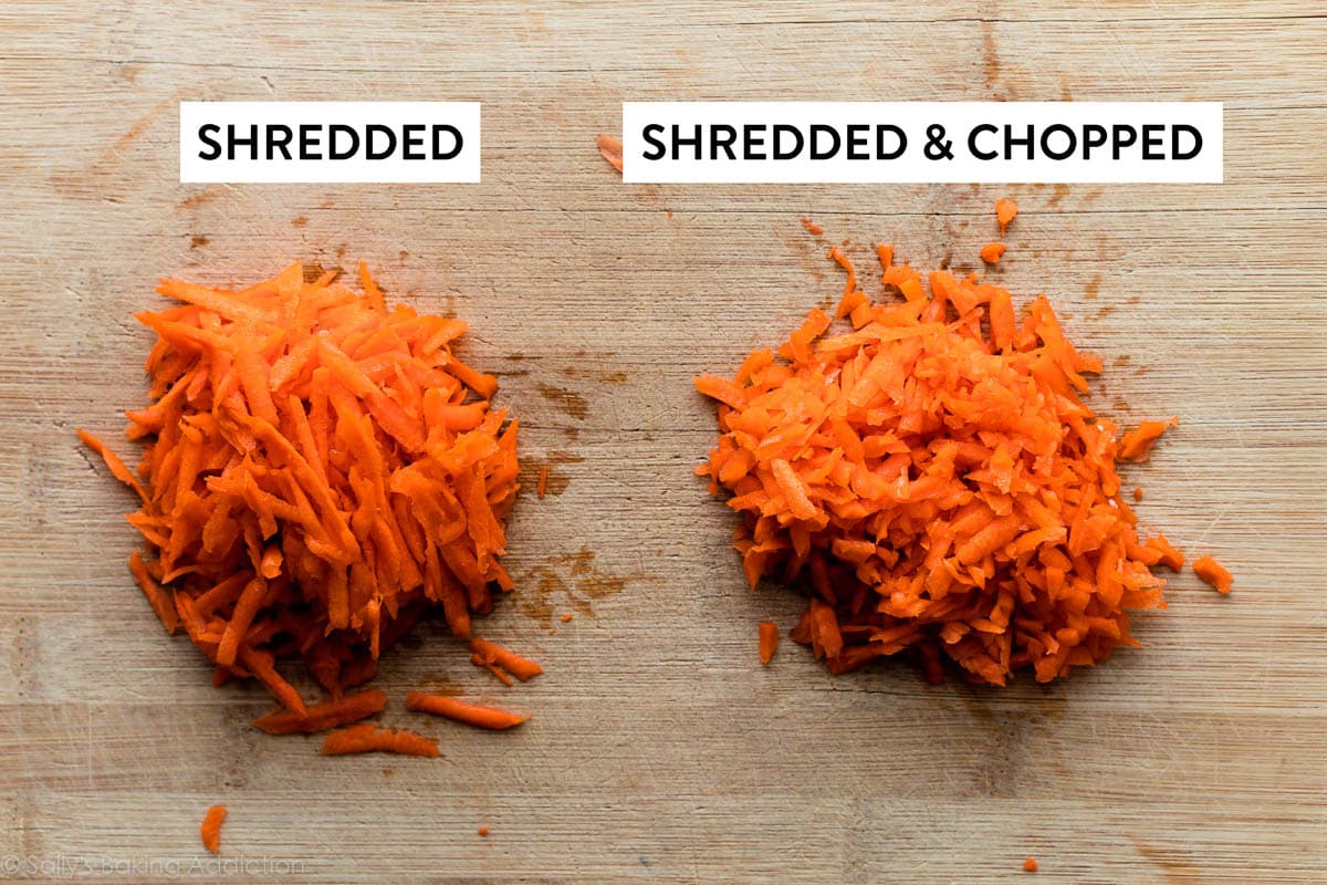 two piles of shredded carrots on wooden cutting board