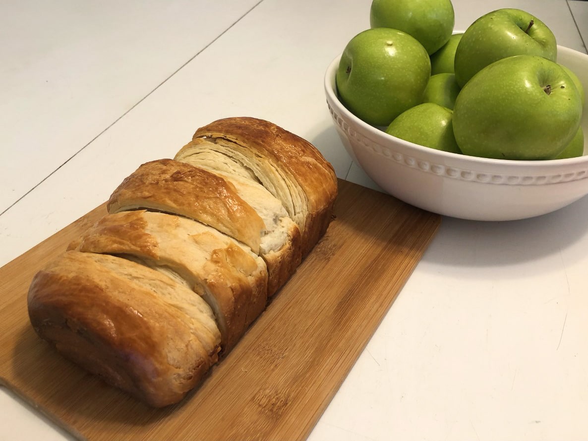 loaf of croissant bread on cutting board