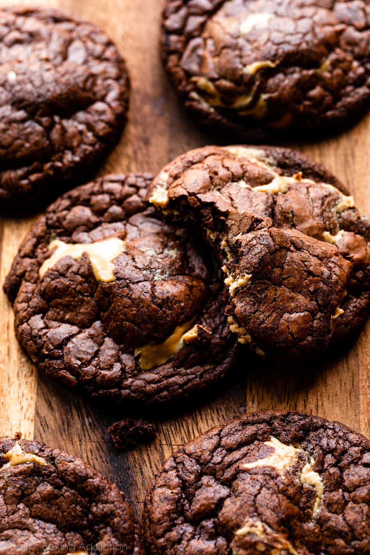 brownie cookies filled with peanut butter on wooden cutting board