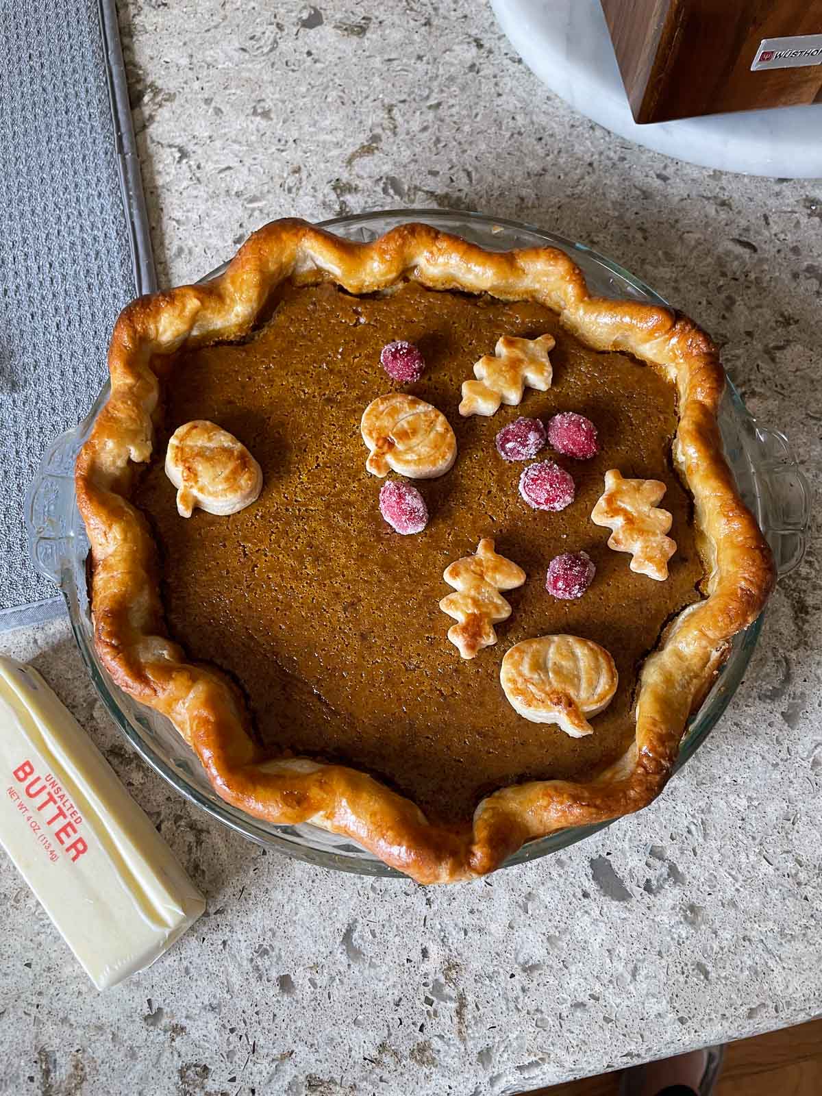 pumpkin pie with leaf-shaped pie crust cut outs on top.