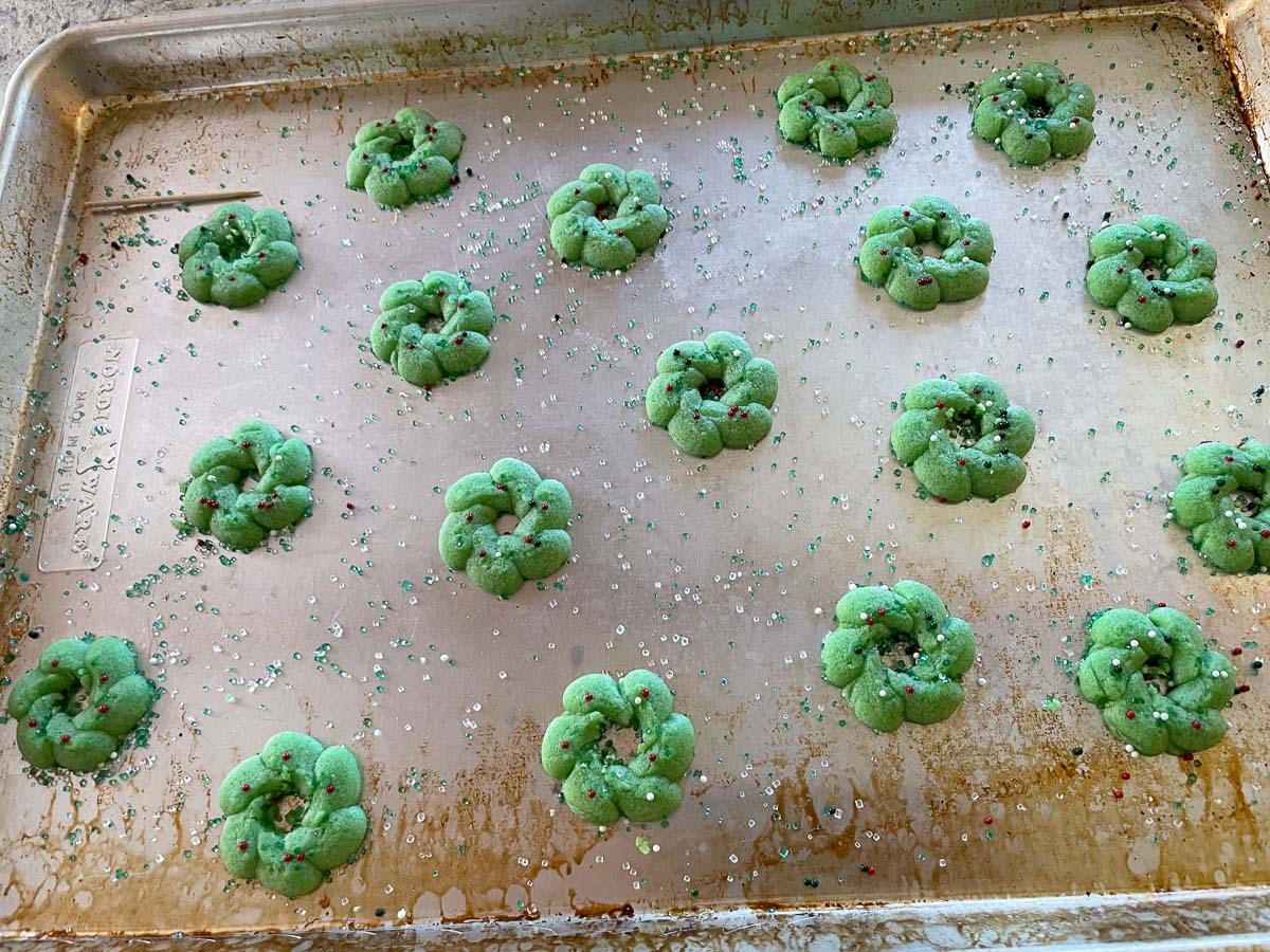 green spritz cookies on baking sheet.