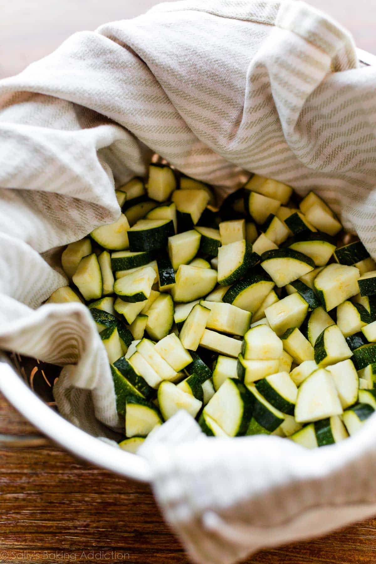 Chopped zucchini in a colander lined with a towel