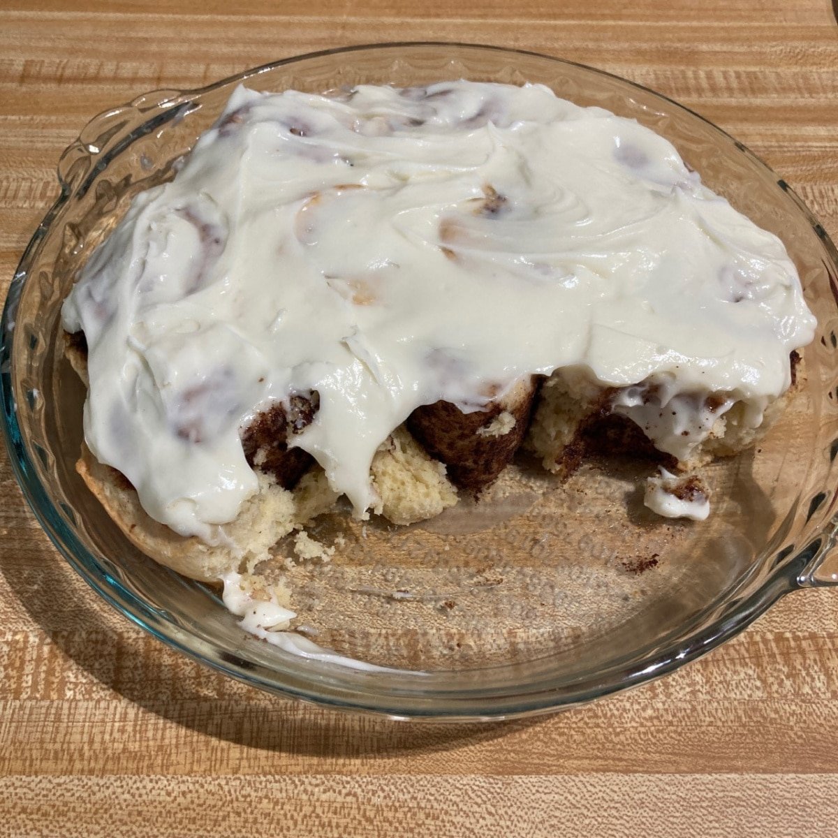Winner's photo of no yeast cinnamon rolls in a pie dish with thick icing on top