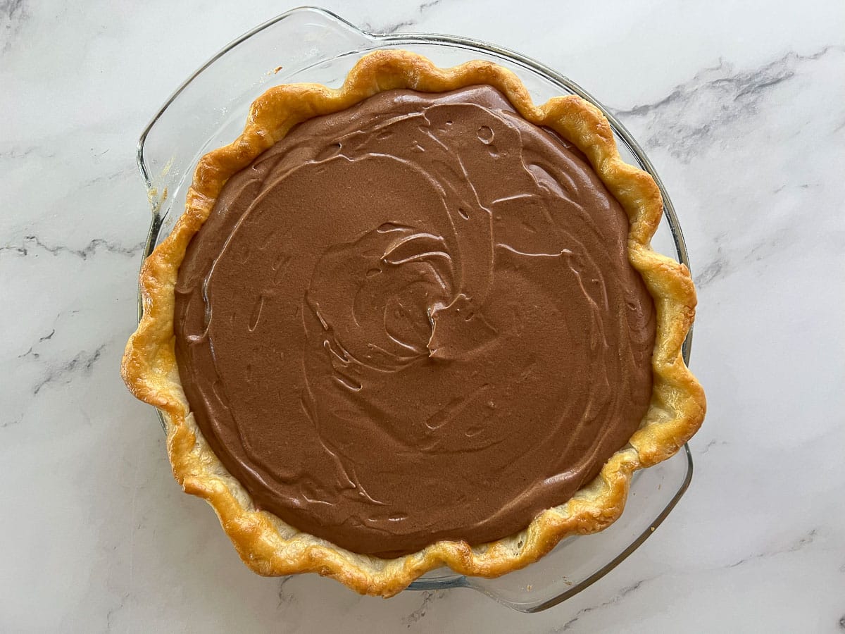 chocolate pie filling inside baked pie crust.