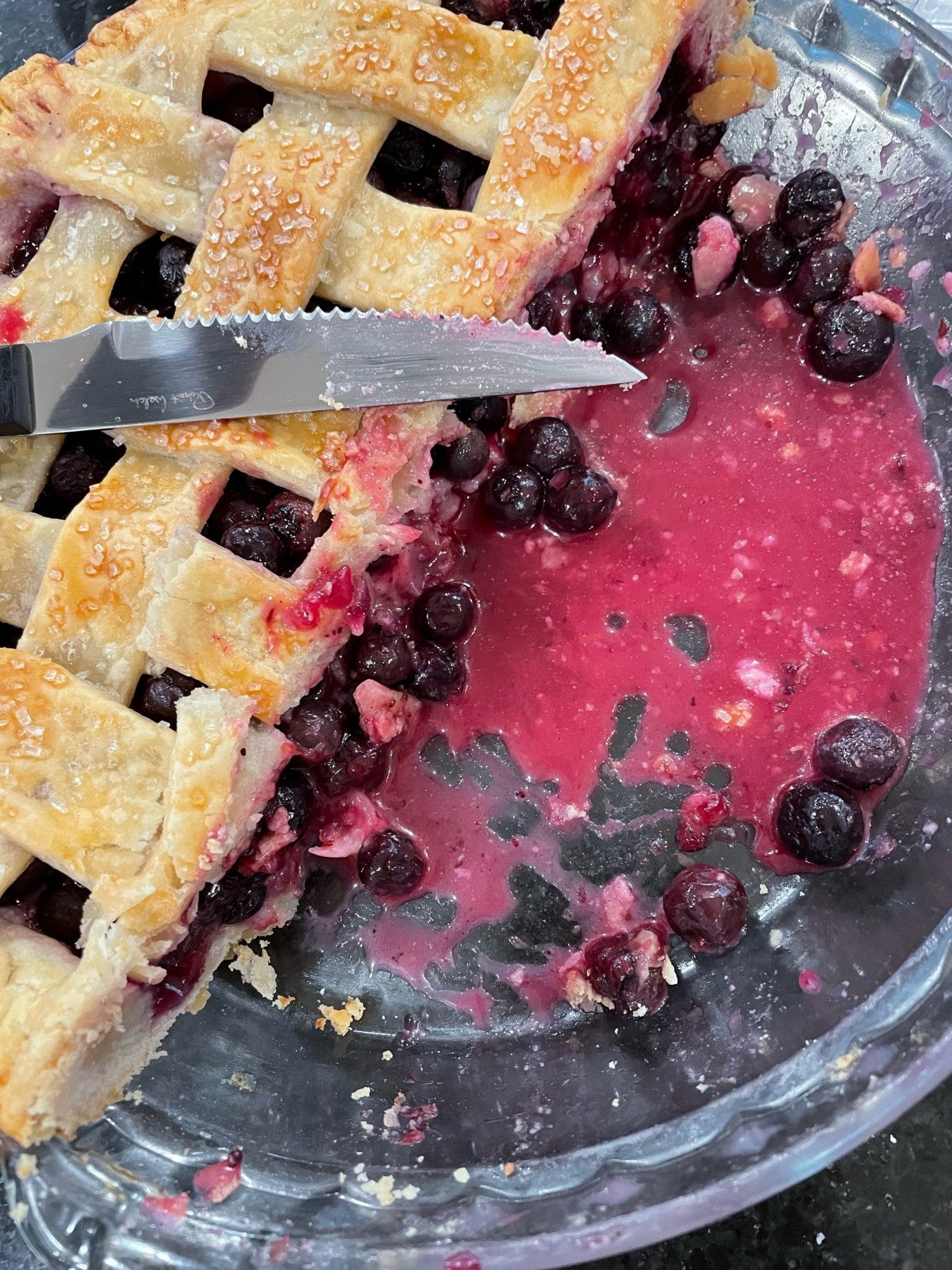 under-baked blueberry pie with raw-looking lattice dough and runny filling.