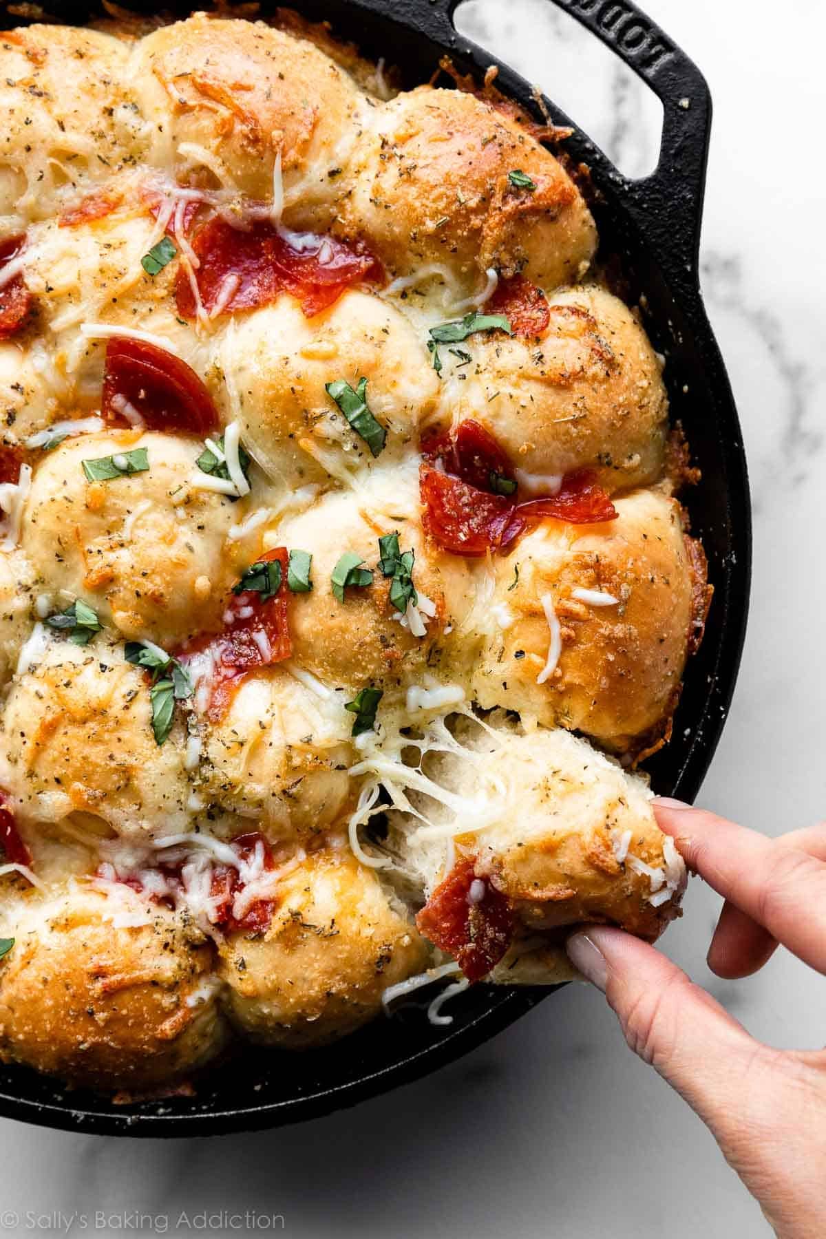 cheesy pizza pull apart rolls in cast iron skillet.