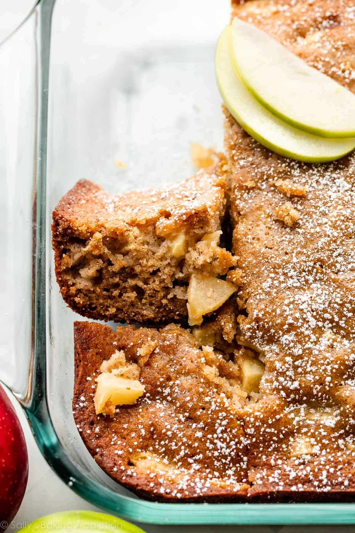 slice of apple cake turned on its side with light dusting of powdered sugar on top.